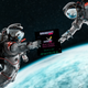 An astronaut hands off an image of HTML game Breakout Hero to another astronaut.